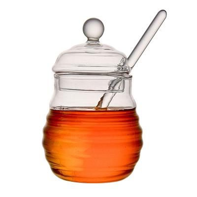 China Heatable Hive Glass Candy Honey Jar With Glass Lid And Plunger for sale