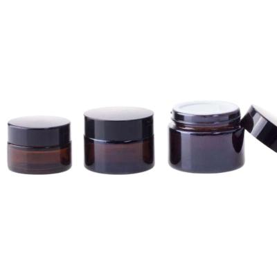 China Personal Care 5g 10g 15g 20g 30g 50g 100g Amber Glass Cream Jar Black Aluminum Cap Frosted Eye Cream Glass Cosmetic Jar for sale