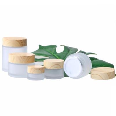 China Personal Care 5g 10g 15g 30g 50g 100g Personal Care Frosted Glass Jar Vial Empty Refillable Cosmetic Cream Jar With Wood Grain Lid Cosmetic Containers for sale