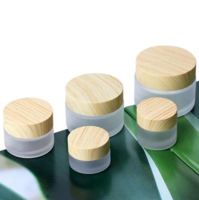 China Personal care 10g 30g 50g 100g frosted cream cosmetic jars with wood grain lids for perfume solid eye emulsion essential oil cream bottles for sale