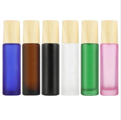 China Personal Care Roll Ball Perfume Roll On Essential Oil Roller Bottle Roll Ball Glass Bottle Frosted Glass Roll On Bottle With Wooden Cap for sale