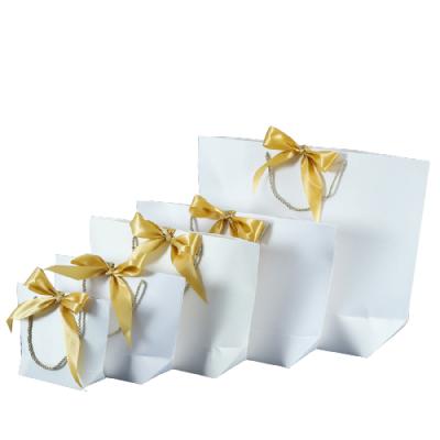 China Delivery Disposable Paper Sack Small Paper Bags Packaging Ribbon Bow Cardboard Luxury Shopping Gift Bags for sale