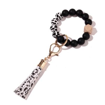 China Leopard Wooden Silicone Tassel Key Chain Bracelet Gift Food Grade Silicone White Disc Beaded Key Chain for sale