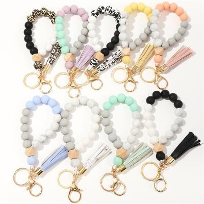 China New Custom Silicone Multicolor Key Bead Key Holder Wristband Ring Cow Leopard Print Wristband Key Chain for sale