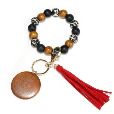 China Daily Life Monogram Cheetah Print Wood Beaded Tassel Silicone Bag Accessories Key Chain Wooden Key Chain for sale