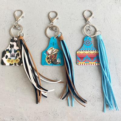 China Hot Selling Souvenir Gifts Promotion Western Farmhouse Cow Sunflower Leather Copy Handcrafted Tassel Metal Key Chain for sale