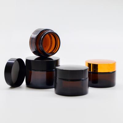 China Hot Selling Personal Care Luxury Eye Cream 10g 15g 20g 30g 50g 100g Amber Glass Jars With Gold Black Lid Bulk for sale