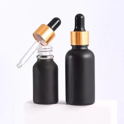 China Personal care 5ml, 10ml, 15ml, 20ml, 30ml, 50ml, 100ml black essential oil dropper glass bottle with gold dropper cap for sale