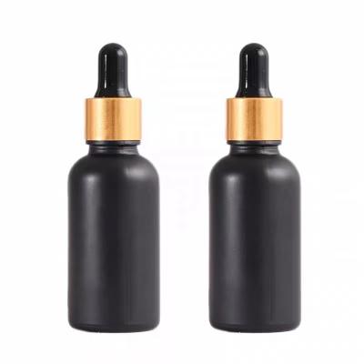 China Low Price Essential Oil Glass Cosmetic Luxury Empty Amber Spray Bottle Matte Black And Gold Dropper for sale