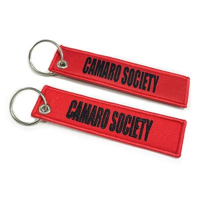 China Promotion Souvenir Gifts Custom Logo Embroidered Brand Name Fabric Key Chain for sale