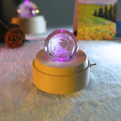 China Modern Warm Crystal Ball Wind Up Rotating Usb Round Music Box Led Lamp Wooden Base for sale