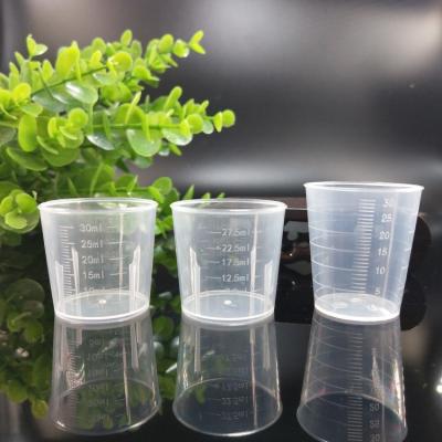 China BPA Free White Transparent Round Cups 30ml Plastic Measuring Cup For Medical Liquid Measuring for sale