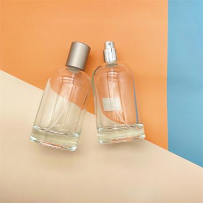 China 180ml Oblique Shoulder Clear Round Perfume Men Cosmetic Perfume Bottles With Sliver Cap for sale