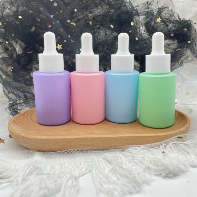 China 30ml Matt Cosmetic Pink Blue Color Essential Oil Flat Shoulder Glass Dropper Bottles for sale