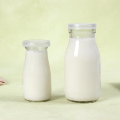 China Beverage 200ML 250ML 500ML 1000ML Milk Glass Bottle With PE Lid And Tin Cap for sale