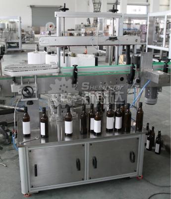 China Automatic Double Side Labeling Machine Cold Glue Labeling Machine For Round Bottles for sale