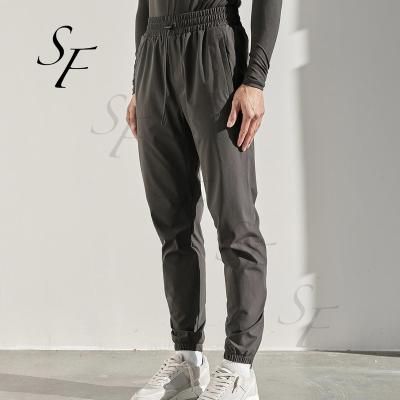 China Anti-Wrinkle Custom Woven Pocket Drawstring Pants Big Stretch Loose Casual Running Joggers Sport Sweatpants Men for sale