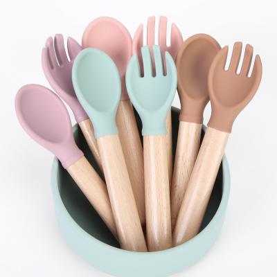 China BPA Free Custom Wooden Handle Fork and Bowl Feeder Set Wooden Handle Silicone Bib Spoon Bowl Baby for sale