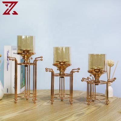 China Home decoration factory price living room decoration gold candle holder metal candlestick with metal base for sale