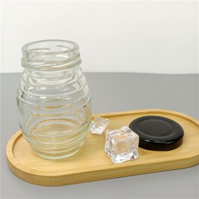 China Food Free Sample Wire Bee Shape Empty Jam Honey Glass Jar With Metal Lid for sale