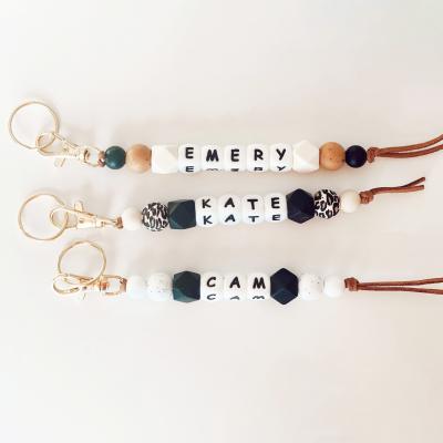 China Fasion Silicone Bag Wooden Beaded Accessories Letter Handmade Custom Leather Rope Key Chain Key Chain For Gift for sale