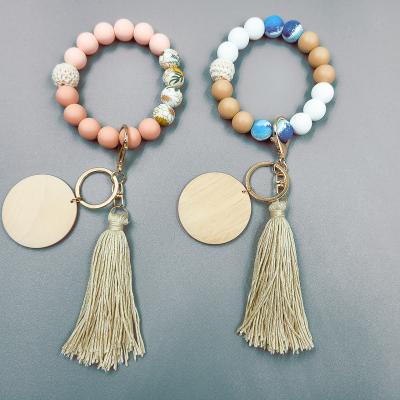 China Monogrammed Wooden Disc Eco - Friendly Knitting Floral Stretchy Silicone Beaded Bracelet Key Chain With Macrame for sale