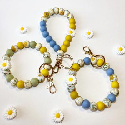 China Boho Boho Bracelet Girls Birthday Gift Badge Holder Daisy Sunflower Pattern Shape Beads Key Ring Silicone Beaded Bracelet Key Chain for sale