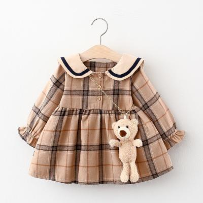 China Washable Kids Clothes British Autumn Winter Clothing Little Girl Plaid Skirt Dress With Bear Pendant for sale