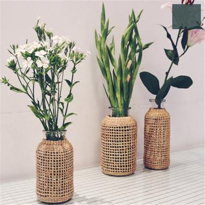 China New classic/postmodern hot sales flower pot glass flower vase with rattan stand hand-produced for sale