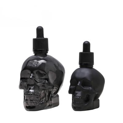 China Cosmetic 30ml 60ml 120ml Unique Skull Shaped Bright Matte Black Glass Serum Bottle Dropper for sale