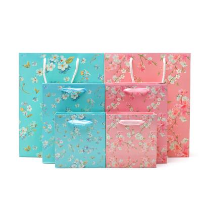 China Flower Pattern Sturdy Cardboard Paper Tote Bag With Handles For Girl'S Birthday Gift for sale