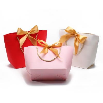 China Compact Gorgeous Cardboard Paper Gift Tote Bag Bowknot Ornament for Birthday for sale