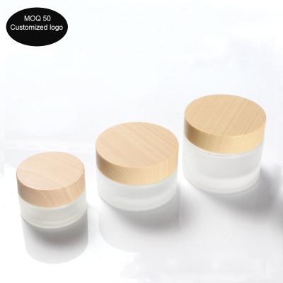 China 30g Matte Glass Cream Jar Empty Frosted Cosmetic Cream Jar Sub-Bottle For Cosmetic Packaging With Wood Grain Cove 1oz à venda