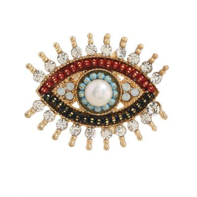 China Popular Small Rhinestone Black Blue Eye Brooches Women Alloy Simulated Pearl Eye Collar Pins Fashion Brooches Gifts for sale