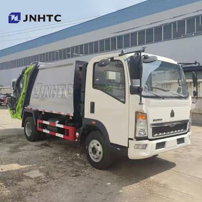 China Garment Shops SINOTRUK HOWO 12m3 4x2 Compactor Garbage Light Truck for sale