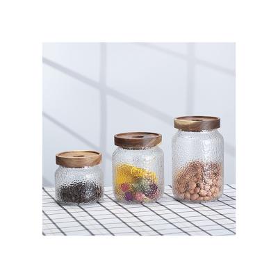 China Kitchen Heatable Storage 350ml 500ml 700ml Hammered Glass Jar With Acacia Wood Lid for sale