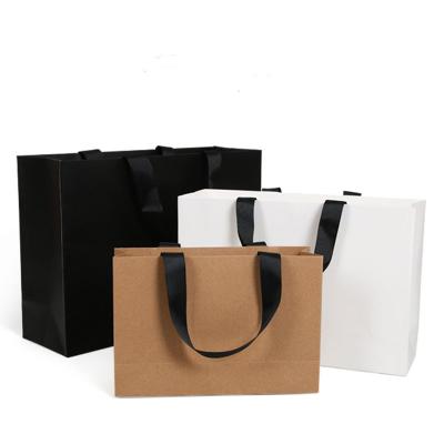 China Recycled Materials Custom Luxury Eco - Friendly Paper Gift Bags Coated Paper Christmas Eve Gift Bags With Thread Rope Handle for sale