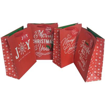 China Recycled Materials Wholesale Fashion Custom Printed Glitter Kraft Paper Bags Christmas Eve Party Gift Paper Bags With Ribbon Handle for sale