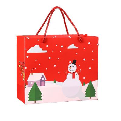 China Recycled Materials Custom Luxury Eco - Friendly Paper Gift Bags Christmas Eve Gift Bags With Three Strand Coated Paper Handle for sale