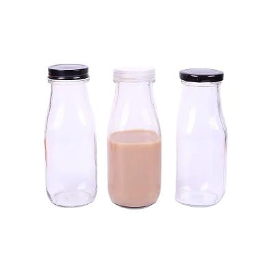 China Sustainable/Eco-Friendly/Stocked Round 300ml Clear Round Juice Milk Water Beverage Bottle Empty Recycled Glass Milk Bottle Empty Container With Lids for sale