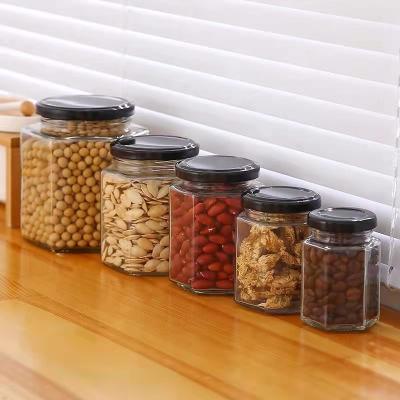 China Factory Price Hexagon Stocked Glass Jars With Sealable Tin Lid for sale