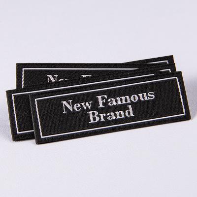 China Sustainable Garment Accessories Black Woven Label Customize Printing Logo Fabric Label for sale