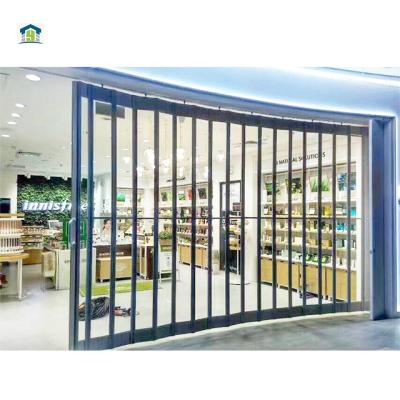 China Transparent Store Front Aluminum Transparent Polycarbonate Folding Plastic Accordion PVC Sliding Grill Doors for sale