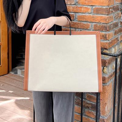 China Buy non woven bags with logo custom wholesale ODM clothing shopping bag handle fabric logo recyclable packaging bags for sale