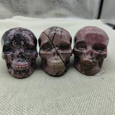 China China Wholesale Hot Sale Natural Rhodonite Skull Statue Hand-carved Crystal Skull Carving For Decoration for sale