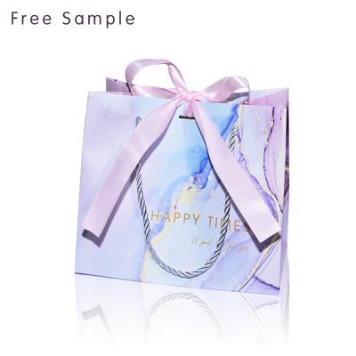 China Recyclable Lipack Custom Free Design Recycled Paper Cosmetics Bag Branded Personalized Gift Packaging Paper Bags With Bow for sale