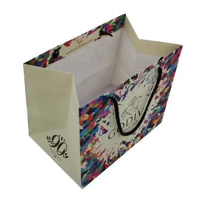 China Recyclable Color Cotton Rope Handle Flower Logo Offset Printing Paper Bag Easy To Fold for sale