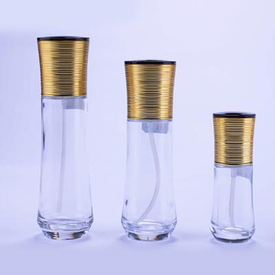 China OEM Style Custom Clear Cosmetic Container Glass Lotion Packaging Empty Pump Bottles With Gold Cap for sale