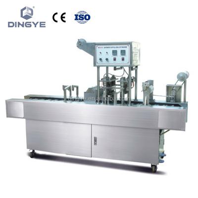 China Automatic milk bottles cutter-shape-seal foil filling and sealing BG48S automatic milk bottle filling and sealing machine in one, foil saving device for sale