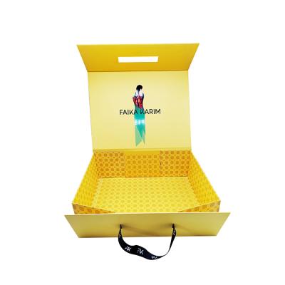 China Recyclable Rigid Yellow Clothes Cardboard Packaging Boxes Folding Magnetic Paper Clothing Box With Ribbon for sale